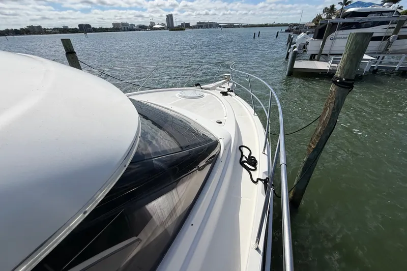 Slide: The Image of 2004 Silverton 43 Motor Yacht docked by the water on a sunny day. - 46