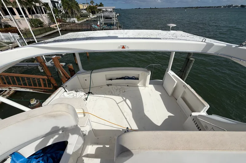 Slide: The Image of 2004 Silverton 43 Motor Yacht deck overlooking serene waterfront and docked boats. - 71