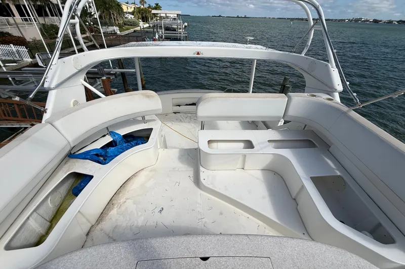 Slide: The Image of 2004 Silverton 43 Motor Yacht deck with seating, overlooking serene waterfront. - 68
