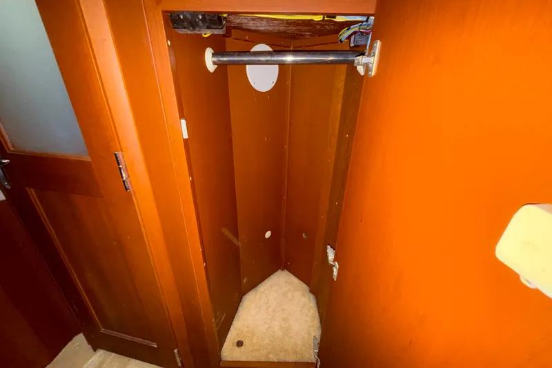 Slide: The Image of Empty wooden closet interior on a 2004 Silverton 43 Motor Yacht. - 143