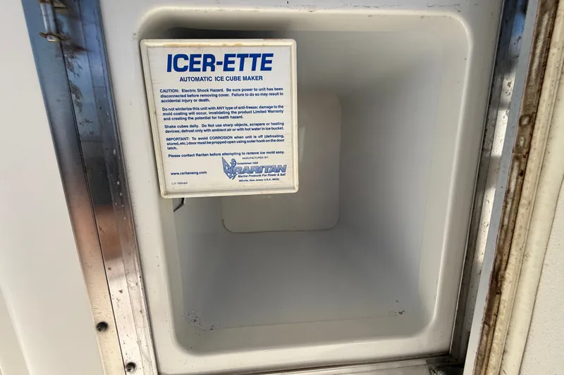 Slide: The Image of Ice maker compartment on a 2004 Silverton 43 Motor Yacht with caution label. - 14