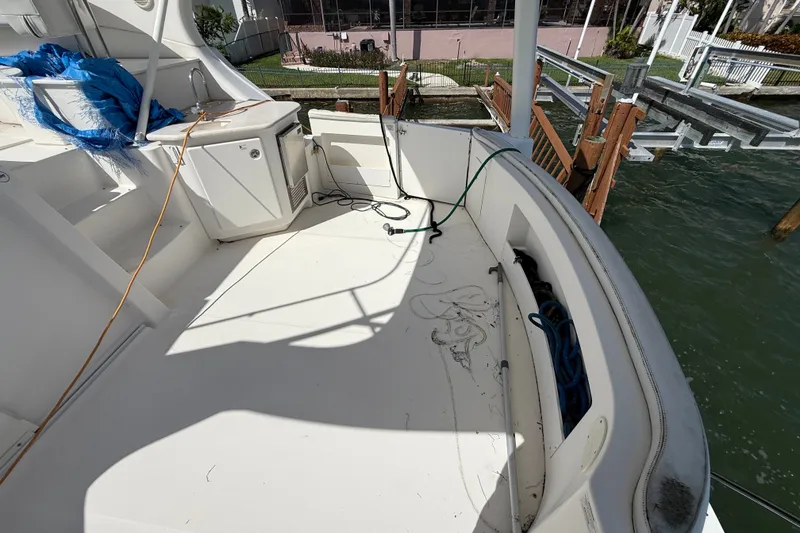 Slide: The Image of 2004 Silverton 43 Motor Yacht deck with storage and dock view. - 9