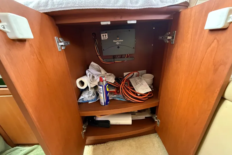 Slide: The Image of Open cabinet in 2004 Silverton 43 Motor Yacht with tools and supplies inside. - 86