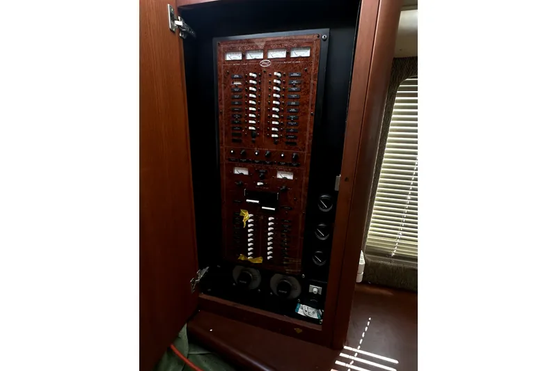 Slide: The Image of Electrical panel inside a 2004 Silverton 43 Motor Yacht, showcasing circuit breakers and controls. - 23