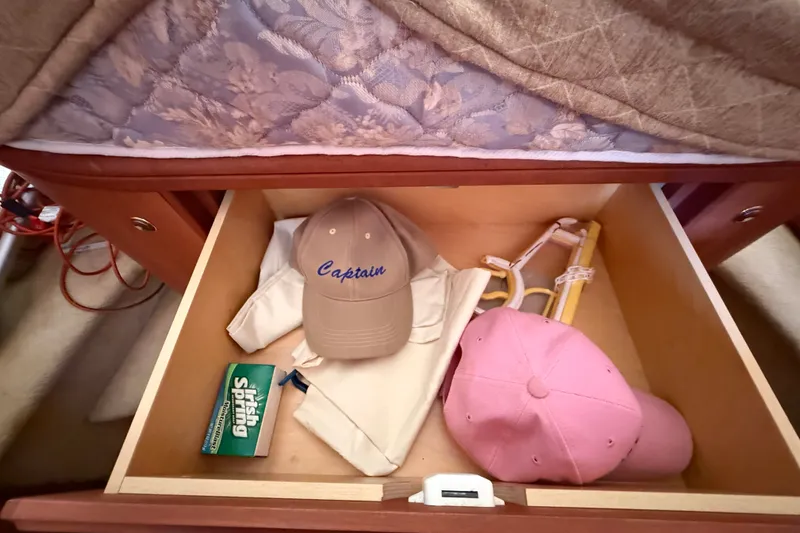 Slide: The Image of Drawer in 2004 Silverton 43 Motor Yacht with hats, shirt, soap, and hanger. - 121