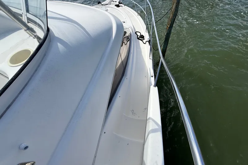 Slide: The Image of 2004 Silverton 43 Motor Yacht deck view with railing and water. - 44