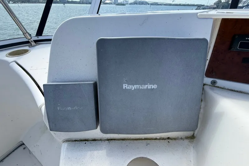 Slide: The Image of Raymarine equipment on 2004 Silverton 43 Motor Yacht dashboard, overlooking water. - 32