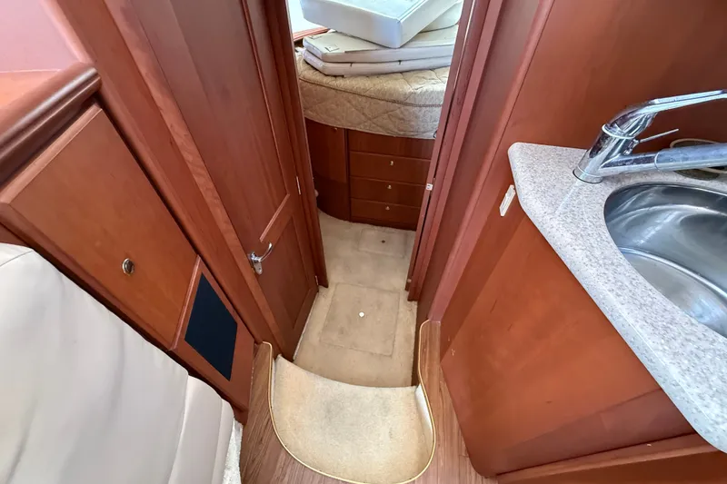 Slide: The Image of Interior of 2004 Silverton 43 Motor Yacht with wood cabinetry and compact sink. - 113