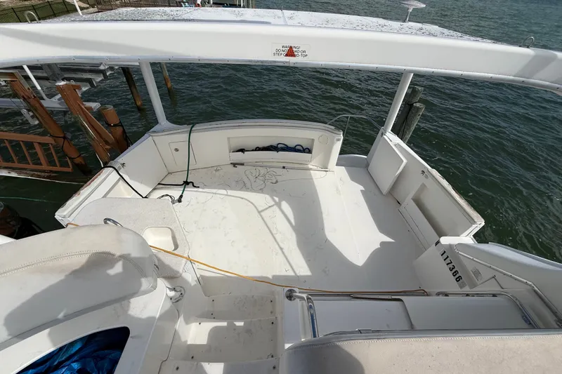 Slide: The Image of 2004 Silverton 43 Motor Yacht deck overlooking water, featuring spacious seating area. - 72
