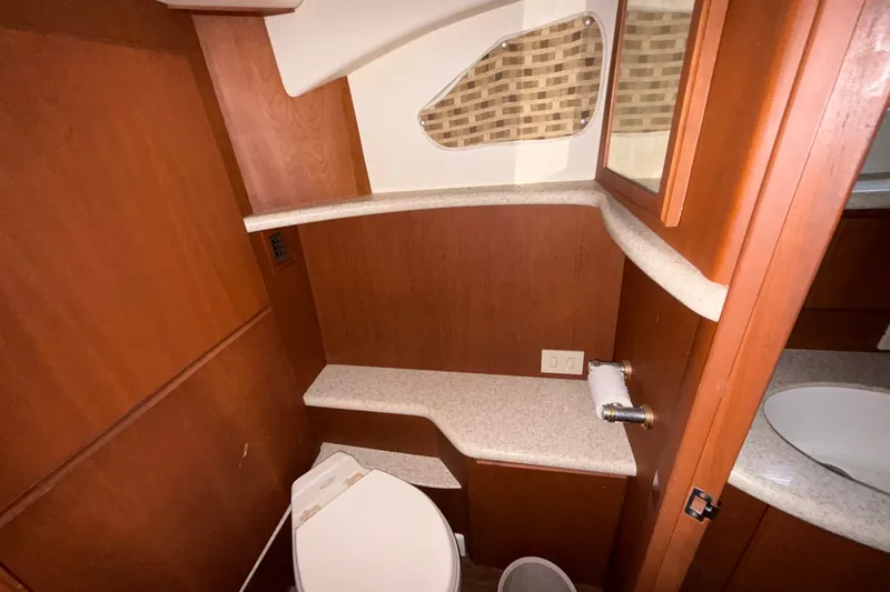 Slide: The Image of Bathroom interior of 2004 Silverton 43 Motor Yacht with wood paneling and countertop. - 153