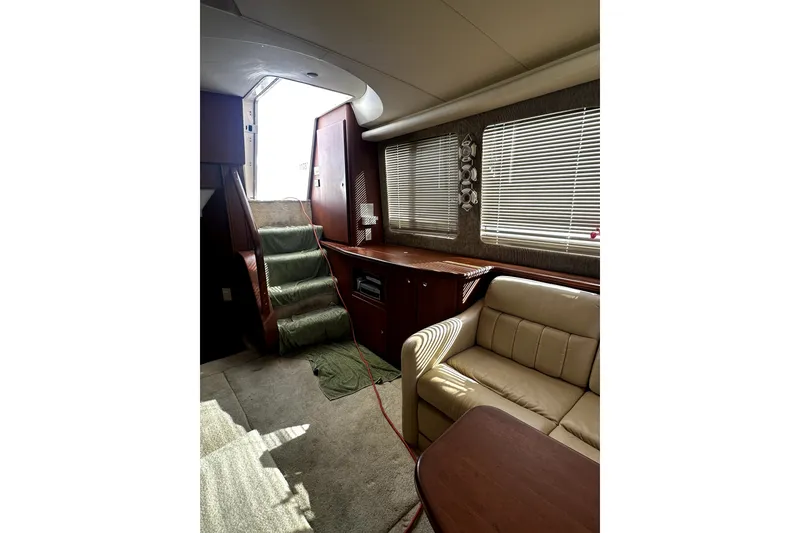 Slide: The Image of Interior of 2004 Silverton 43 Motor Yacht with stairs, sofa, and window blinds. - 6