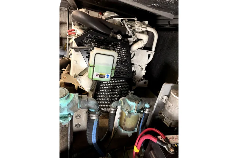 Slide: The Image of Engine compartment of a 2004 Silverton 43 Motor Yacht, showcasing mechanical components and wiring. - 13