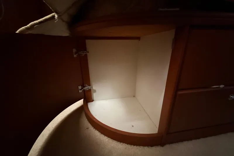 Slide: The Image of Open cabinet inside 2004 Silverton 43 Motor Yacht, showcasing interior storage space. - 158