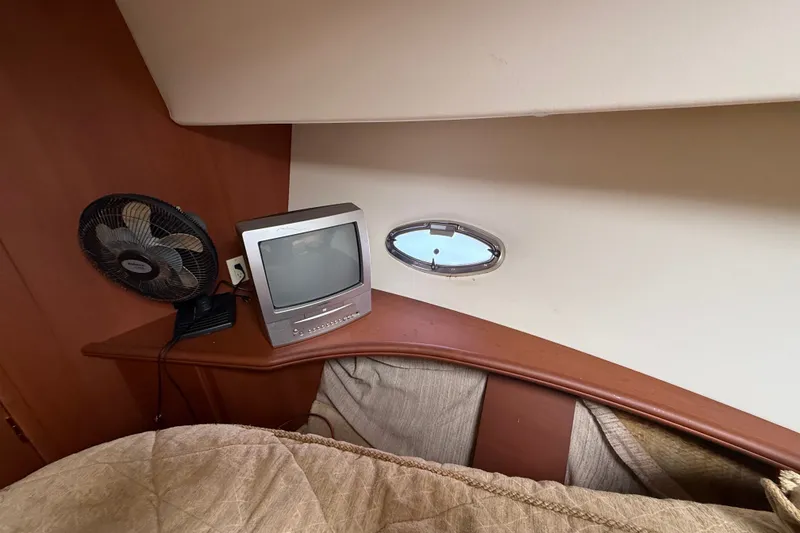 Slide: The Image of 2004 Silverton 43 Motor Yacht interior with TV, fan, and porthole window. - 130