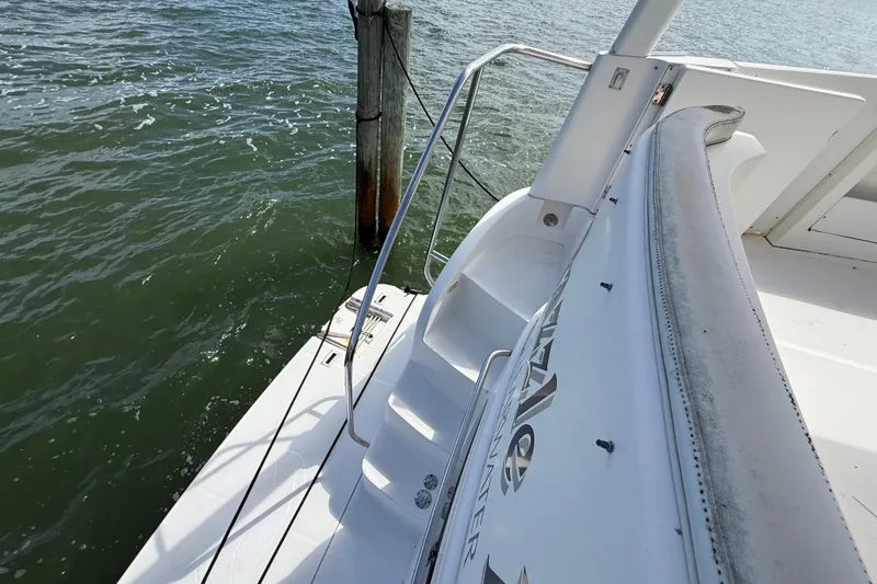 Slide: The Image of 2004 Silverton 43 Motor Yacht deck with railing, docked by water. - 77