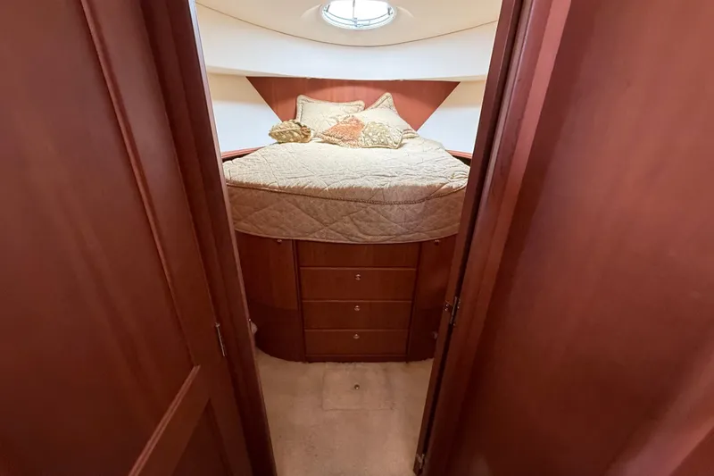 Slide: The Image of Cozy bedroom interior of 2004 Silverton 43 Motor Yacht with elegant wood finish. - 118