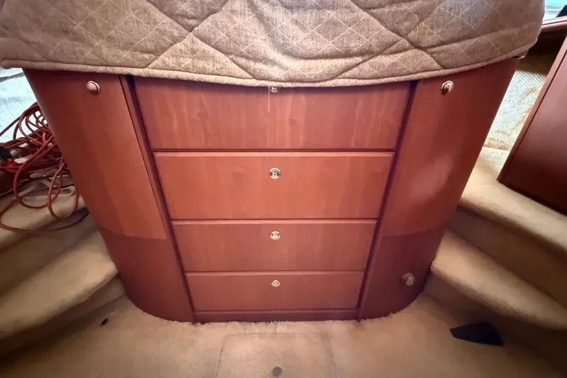 Slide: The Image of Interior of 2004 Silverton 43 Motor Yacht with wooden drawers and carpeted steps. - 120