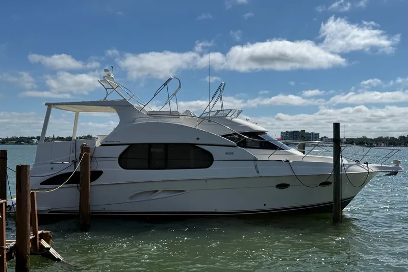 Slide: The Image of 2004 Silverton 43 Motor Yacht docked on a sunny day with blue sky. - 1