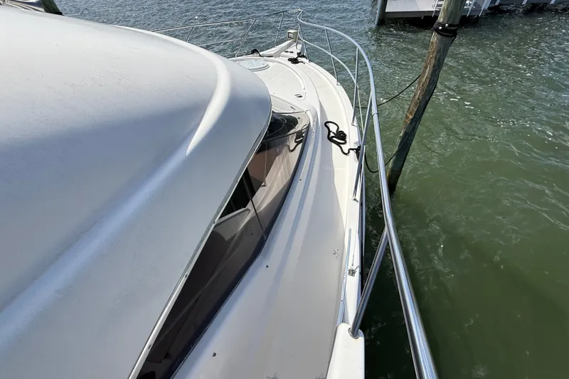 Slide: The Image of 2004 Silverton 43 Motor Yacht docked, showcasing sleek design and railing details. - 45
