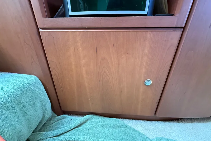 Slide: The Image of Interior of 2004 Silverton 43 Motor Yacht with wooden cabinetry and green towel. - 84
