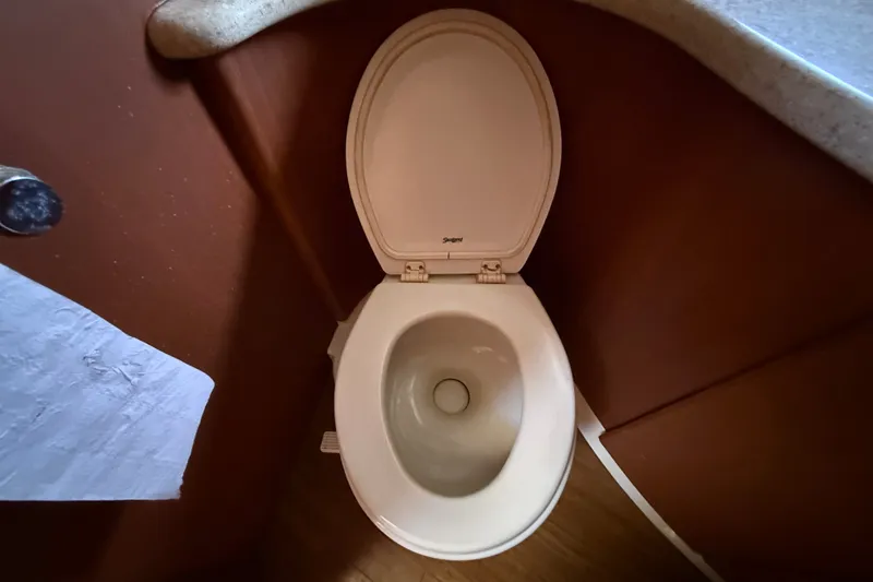 Slide: The Image of Toilet in 2004 Silverton 43 Motor Yacht bathroom, featuring a compact design. - 117