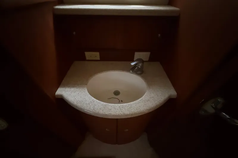 Slide: The Image of Bathroom sink in 2004 Silverton 43 Motor Yacht, featuring a modern faucet and countertop. - 147