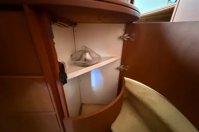 Slide: The Image of Open cabinet inside 2004 Silverton 43 Motor Yacht, revealing storage space and shelf. - 126
