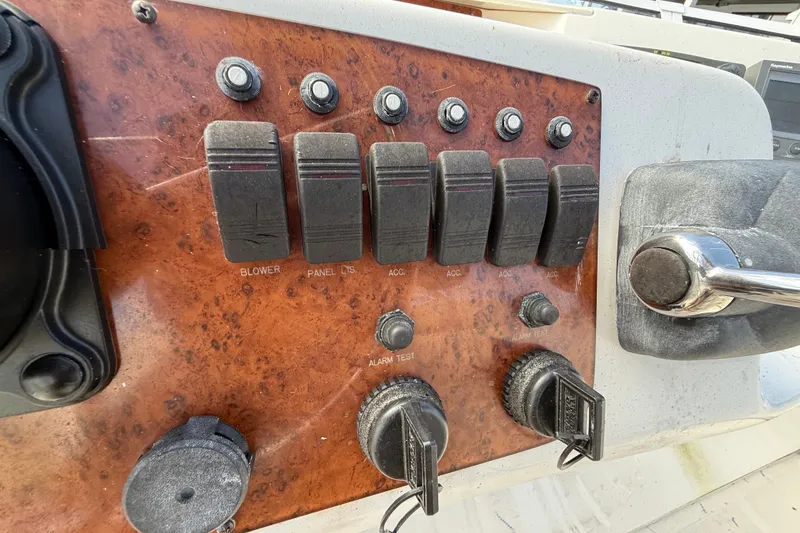 Slide: The Image of Control panel of a 2004 Silverton 43 Motor Yacht with switches and knobs. - 36