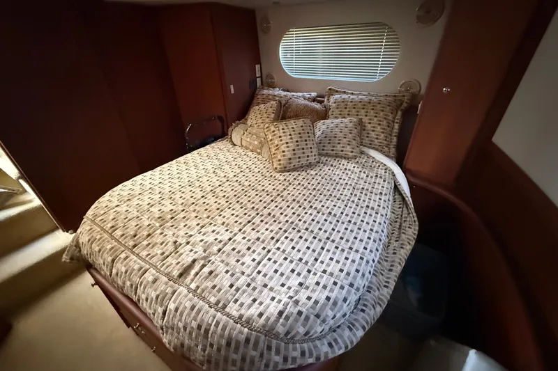 Slide: The Image of Luxurious bedroom interior of 2004 Silverton 43 Motor Yacht with patterned bedding. - 160