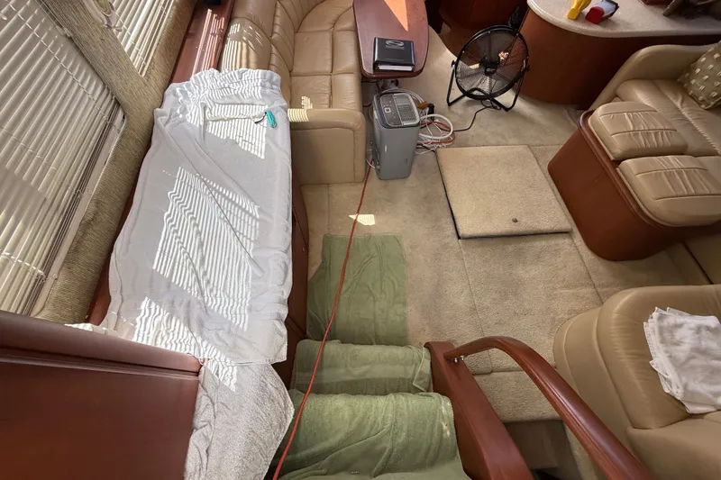 Slide: The Image of Interior of 2004 Silverton 43 Motor Yacht with beige seating and wooden accents. - 82