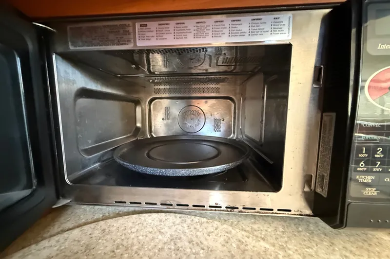 Slide: The Image of Open microwave oven with a rotating glass plate inside, on a Silverton 43 Motor Yacht. - 108