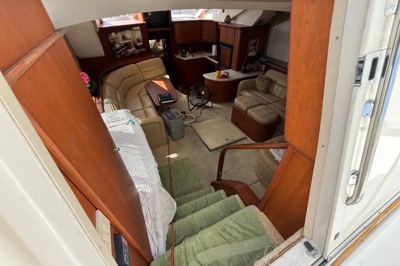 Slide: The Image of Interior of 2004 Silverton 43 Motor Yacht with cozy seating and wooden cabinetry. - 80