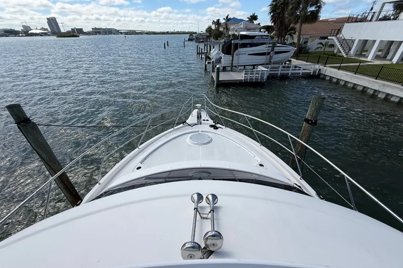 Slide: The Image of Bow view of 2004 Silverton 43 Motor Yacht docked by waterfront homes. - 39