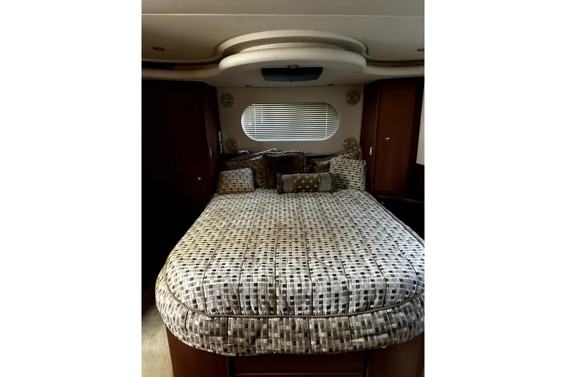 Slide: The Image of Luxurious bedroom interior of 2004 Silverton 43 Motor Yacht with patterned bedding and elegant design. - 9
