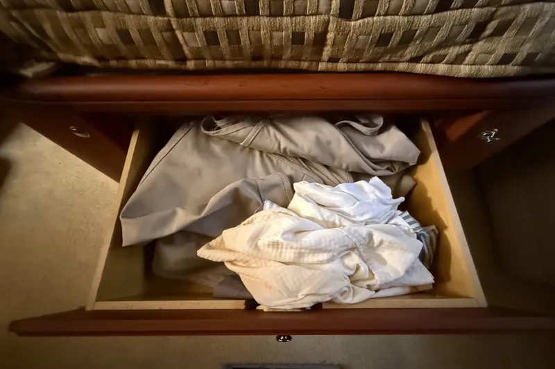 Slide: The Image of Open drawer with folded clothes inside a 2004 Silverton 43 Motor Yacht. - 156