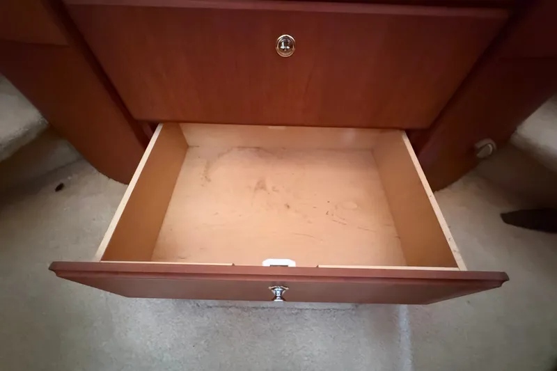 Slide: The Image of Open wooden drawer inside a 2004 Silverton 43 Motor Yacht, showcasing interior storage space. - 124
