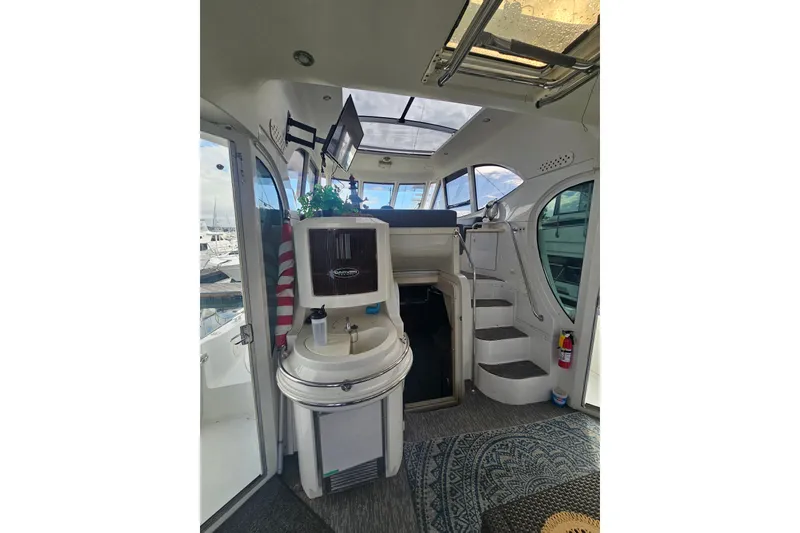 Slide: The Image of Interior of 2001 Carver 564 Cockpit Motor Yacht with stairs and seating area. - 9