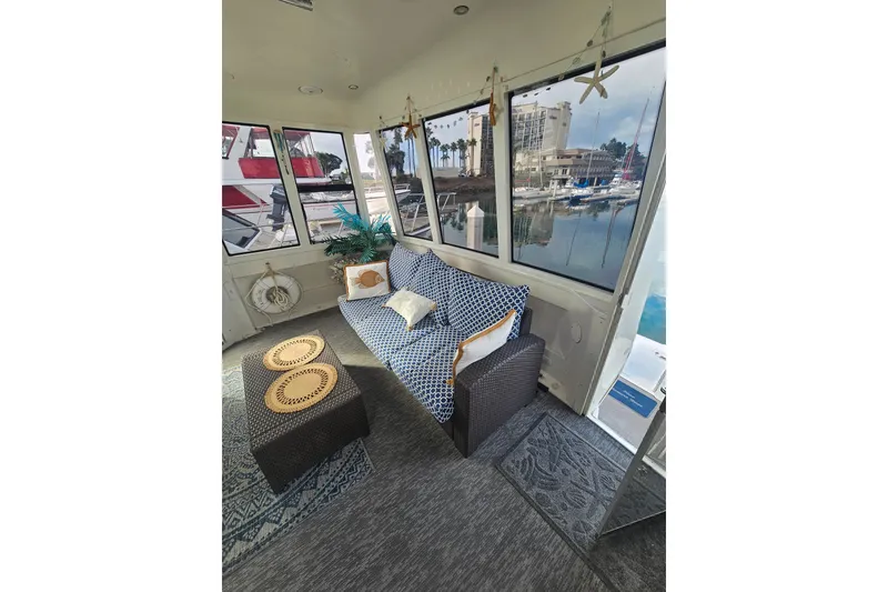 Slide: The Image of Interior of 2001 Carver 564 Cockpit Motor Yacht with cozy seating and marina view. - 10