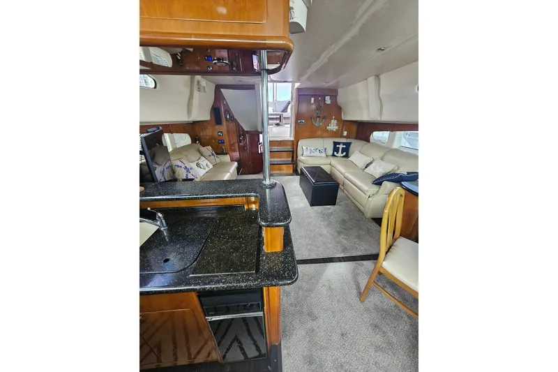 Slide: The Image of Interior of 2001 Carver 564 Cockpit Motor Yacht with luxurious seating and modern amenities. - 13