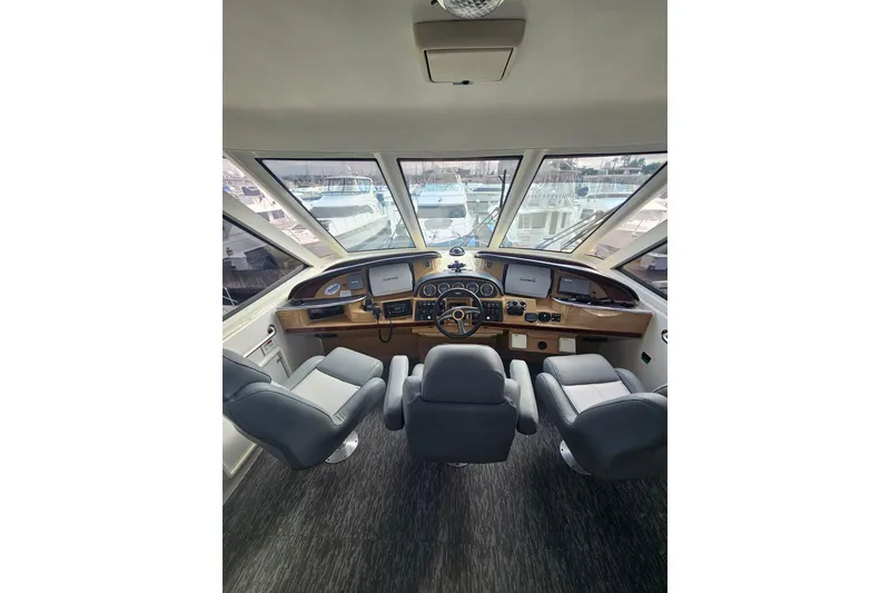 Slide: The Image of Cockpit view of 2001 Carver 564 Cockpit Motor Yacht with modern navigation equipment. - 45