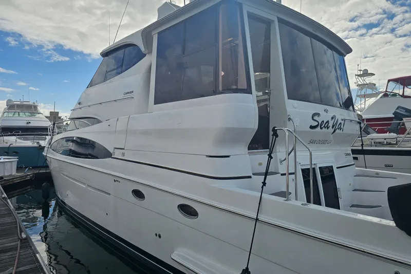 Slide: The Image of 2001 Carver 564 Cockpit Motor Yacht docked at marina under cloudy sky. - 6