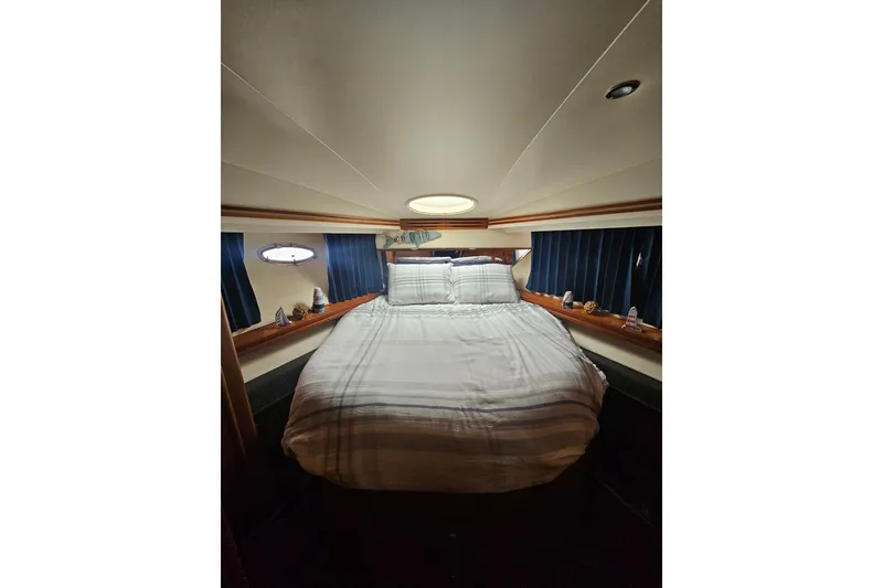 Slide: The Image of Cozy bedroom interior of 2001 Carver 564 Cockpit Motor Yacht with nautical decor. - 19