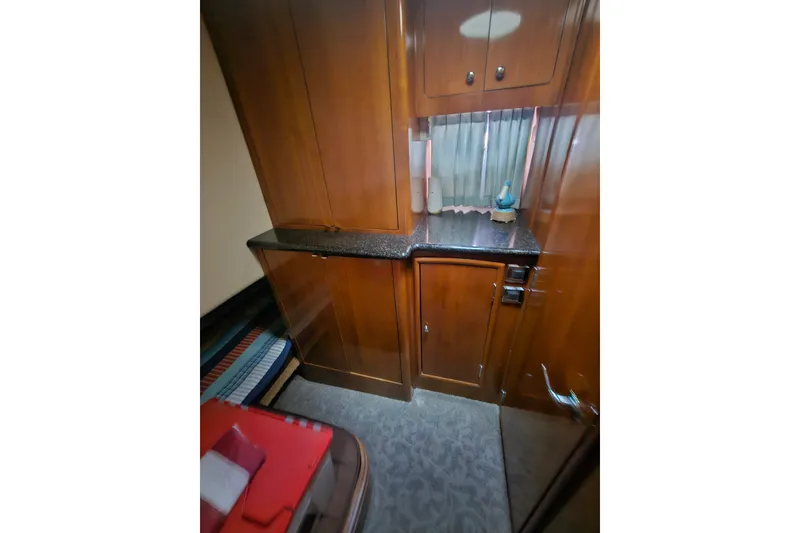Slide: The Image of Interior of 2001 Carver 564 Cockpit Motor Yacht with wooden cabinetry and countertop. - 15