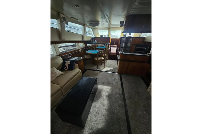 Slide: The Image of Interior of 2001 Carver 564 Cockpit Motor Yacht with seating and dining area. - 27