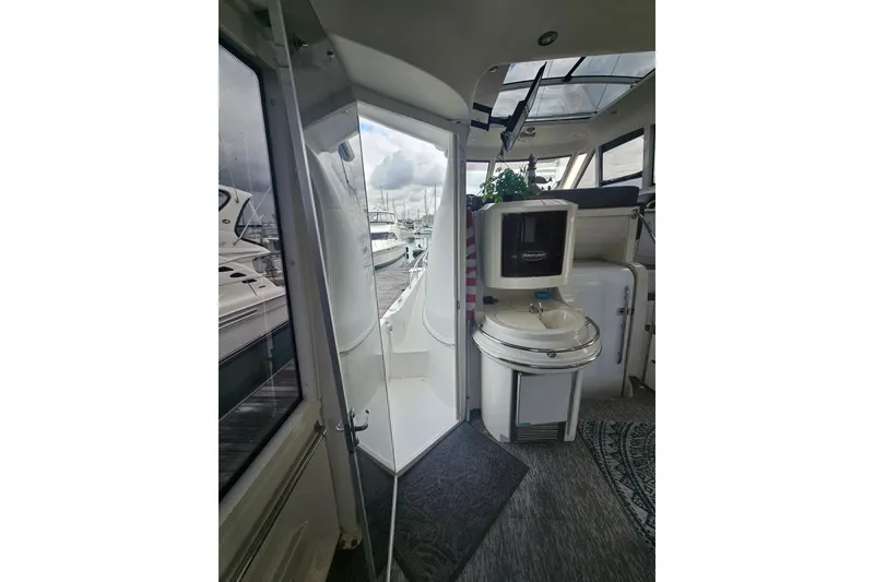 Slide: The Image of Interior view of 2001 Carver 564 Cockpit Motor Yacht, featuring a compact sink and seating area. - 37