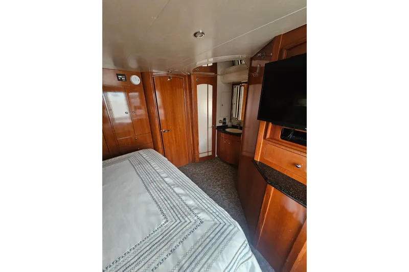 Slide: The Image of Interior of 2001 Carver 564 Cockpit Motor Yacht with wood paneling and modern amenities. - 23