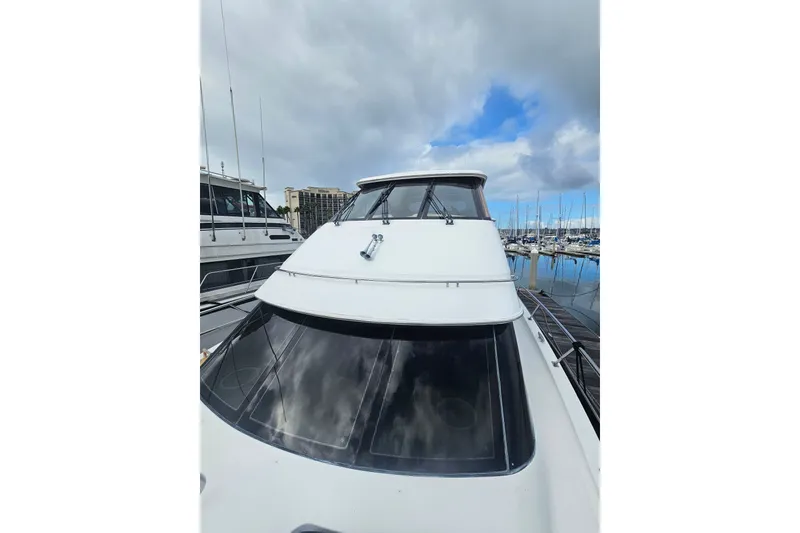 Slide: The Image of 2001 Carver 564 Cockpit Motor Yacht docked at marina under cloudy sky. - 35