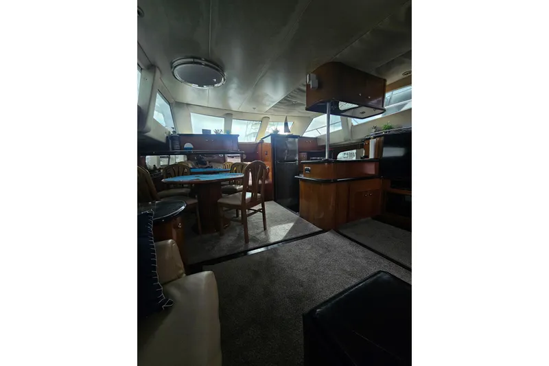 Slide: The Image of Interior of 2001 Carver 564 Cockpit Motor Yacht with dining area and kitchen. - 25
