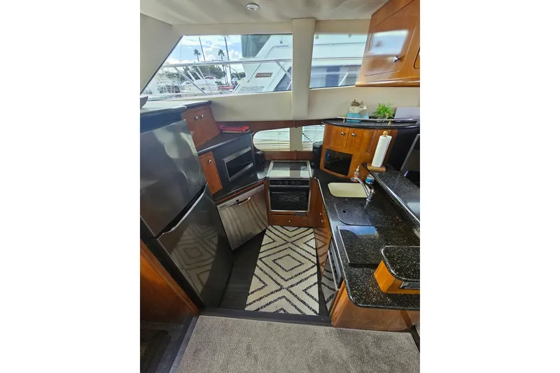 Slide: The Image of Luxurious kitchen interior of 2001 Carver 564 Cockpit Motor Yacht with modern appliances. - 11