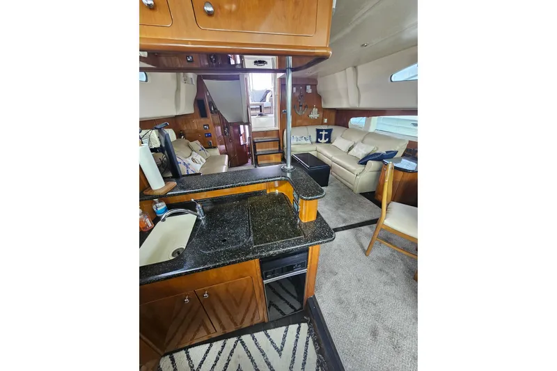 Slide: The Image of Interior of 2001 Carver 564 Cockpit Motor Yacht with kitchen and seating area. - 12